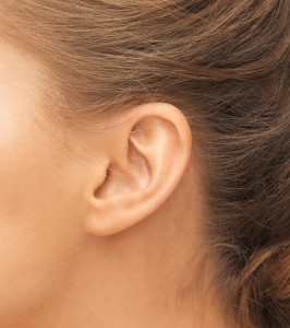 hearing, health, beauty and piercing concept - close up of woman's ear